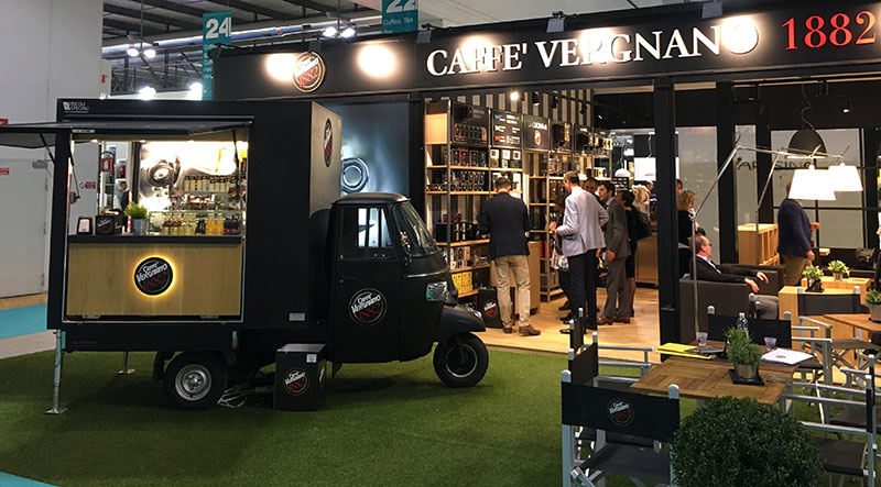 mobile cafeteria vergnano on piaggio ape tr in front of the stand during a fair